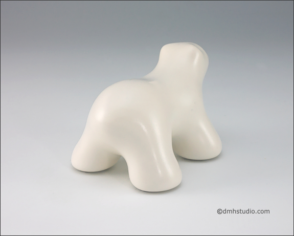 Large image of baby polar bear sculpture in carrara white, facing away and to the right.
