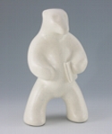 Standing polar bear sculpture with book, in carrara white glaze. Portrait facing slightly to the viewers right.