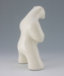 Standing polar bear sculpture with book, in carrara white glaze. Profile facing away and to the viewers right.