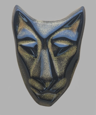 Image of Baby Cat mask in black gold glaze. Portrait facing the viewer.
