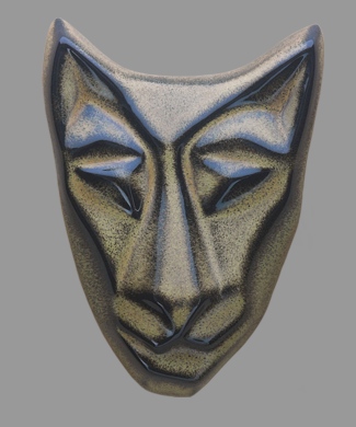 Image of Baby Cat mask in golden black glaze. Portrait facing the viewer.