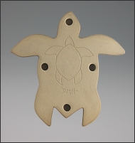 Image of Hanalei Sea Turtle sculpture in black gold glaze, portrait of the back. It shows the unglazed clay with a petrogliph like turtle drawing, mounting holes, and artists marks.