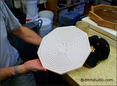 holding a bisque fired finger labyrinth