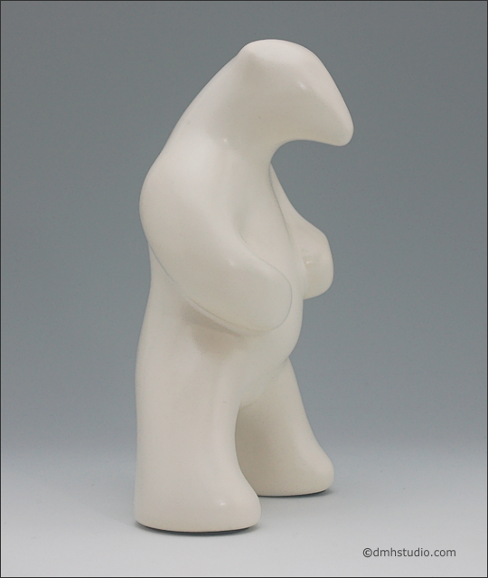 Large image of standing white polar bear sculpture, profile facing the viewers right.