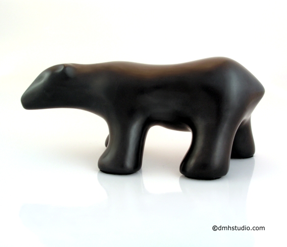 Large image of walking polar bear sculpture in diamond black, profile facing the viewers left.