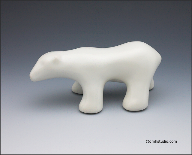 Large image of walking polar bear sculpture in carrara white, profile facing left.