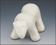 Image of waking polar bear sculpture in carrara white, portrait facing out to the viewer.
