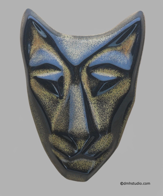 Large image of Baby Cat mask in black gold glaze. Portrait facing the viewer.