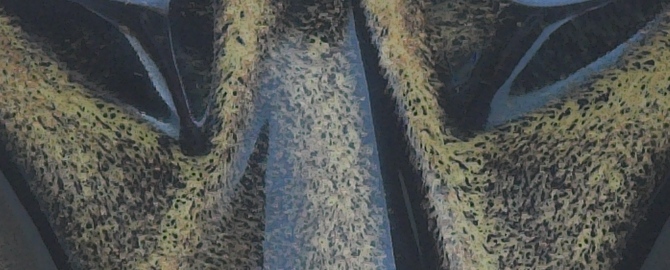 Close-up of baby cat mask in black gold glaze.